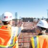 man in white hard hat standing on brown wooden dock during daytime