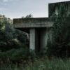 gray concrete house beside trees during daytime