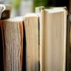 macro photo of five assorted books